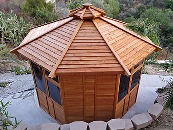 Knotty redwood boards are used throughout this octagonal, enclosed gazebo